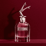 Jean Paul Gaultier So Scandal! Eau de Parfum 80ml displayed against a deep red background, emphasizing its bold and luxurious appeal.