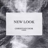 Label of New Look by Dior – Modern Floral Amber Eau de Parfum set against smoky houndstooth fabric, highlighting the elegant branding.