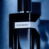 YSL Y Eau de Parfum 100ml bottle in dramatic lighting, showcasing bold black and blue design with Yves Saint Laurent branding.